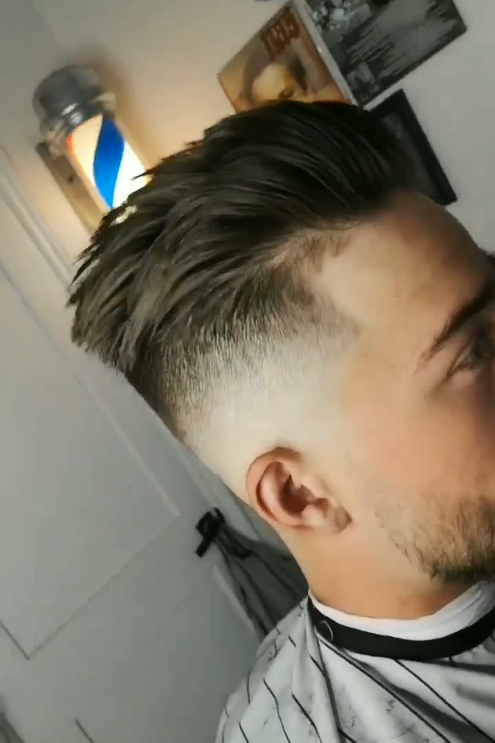 After: a high skin fade with a textured top pushed back, side profile in the shop