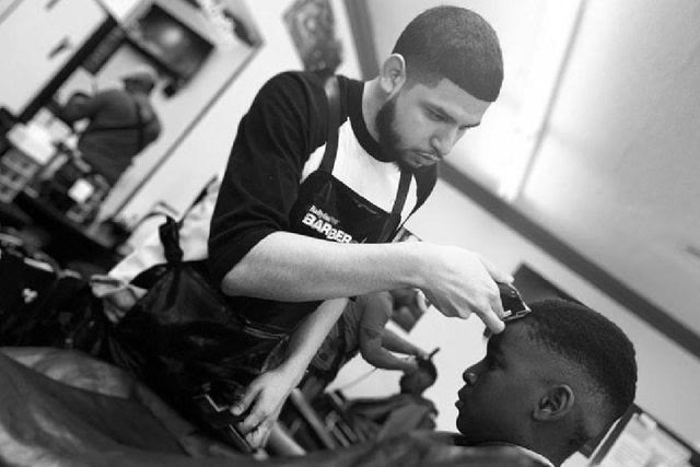 Henry mid-cut, clippers in hand, in black and white